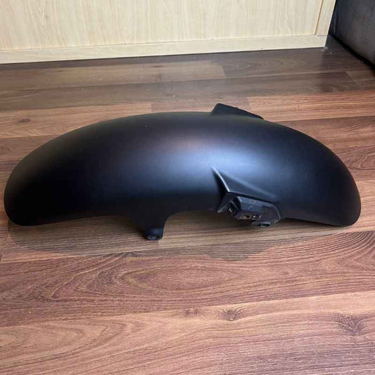Mounted view of the original Yamaha XSR155 OEM front fender showing the factory mounting points and original finish. Genuine Yamaha front mudguard removed from the Neo Muscle project motorcycle in good used condition.