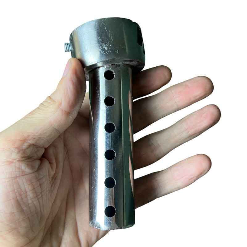 Neo Muscle DB Killer held in hand for Yamaha XSR155 exhaust, stainless steel removable exhaust insert with sound reduction holes.