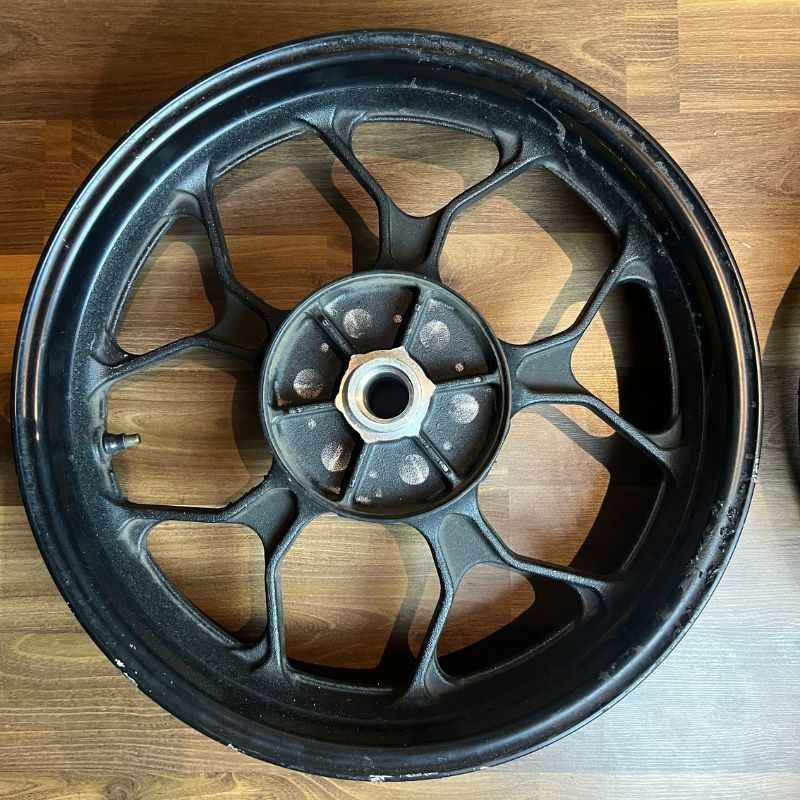 Original Yamaha XSR155 OEM front wheel (velg) removed from the Neo Muscle project motorcycle. Genuine factory front wheel in original condition.