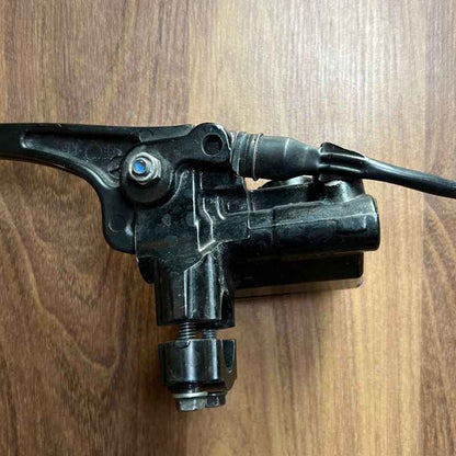 Close-up of the original Yamaha XSR155 OEM clutch lever and clutch perch assembly removed from the Neo Muscle project motorcycle. Genuine factory Yamaha clutch lever with cable adjuster and mounting bracket for OEM replacement or stock restoration.