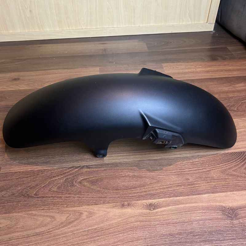 Mounted view of the original Yamaha XSR155 OEM front fender showing the factory mounting points and original finish. Genuine Yamaha front mudguard removed from the Neo Muscle project motorcycle in good used condition.