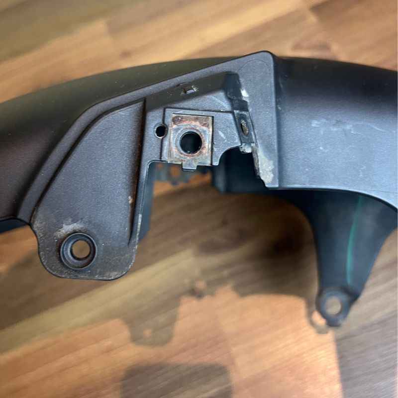 Close-up of the original Yamaha XSR155 OEM front fender mounting point and factory bracket. Genuine Yamaha front mudguard removed from the Neo Muscle project motorcycle, showing the original attachment hardware area.