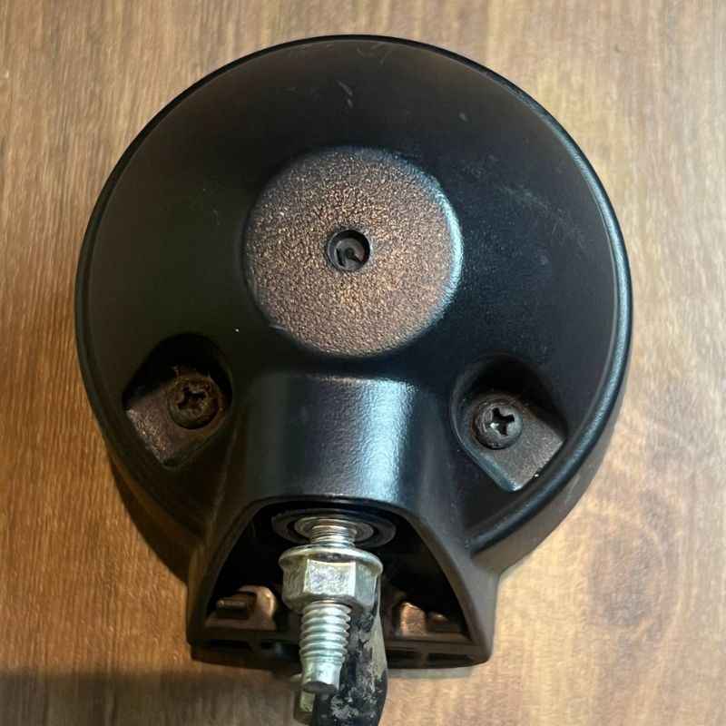 Rear mounting base of the original Yamaha XSR155 OEM rear light showing the factory housing, mounting bolt, screws and wiring outlet. Genuine Yamaha tail lamp, stop lamp and rear lamp assembly removed from the Neo Muscle project motorcycle.
