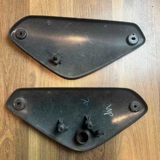 Back side of the original Yamaha XSR155 OEM side covers showing factory mounting tabs, clips and original attachment points. Genuine Yamaha left and right side panels removed from the Neo Muscle project motorcycle.