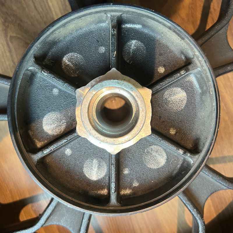 Close-up of the original Yamaha XSR155 OEM rear wheel hub and bearing (velg) removed from the Neo Muscle project motorcycle. Genuine factory wheel component.