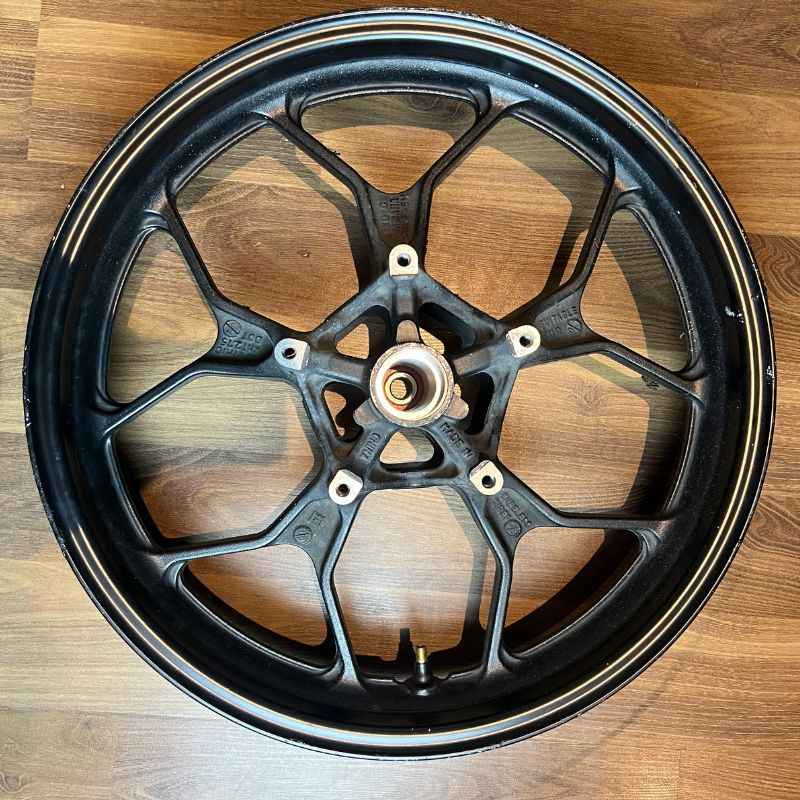 Top view of the original Yamaha XSR155 OEM rear wheel (velg) removed from the Neo Muscle project motorcycle. Genuine factory rear wheel in original condition.