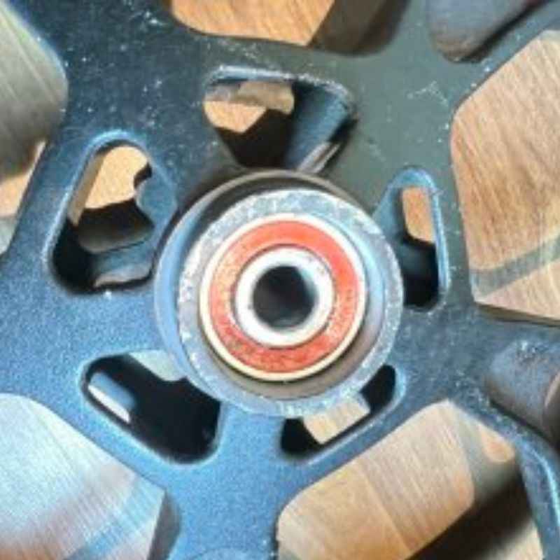 Close-up of the original Yamaha XSR155 OEM wheel bearing (velg) removed from the Neo Muscle project motorcycle. Genuine factory wheel component.