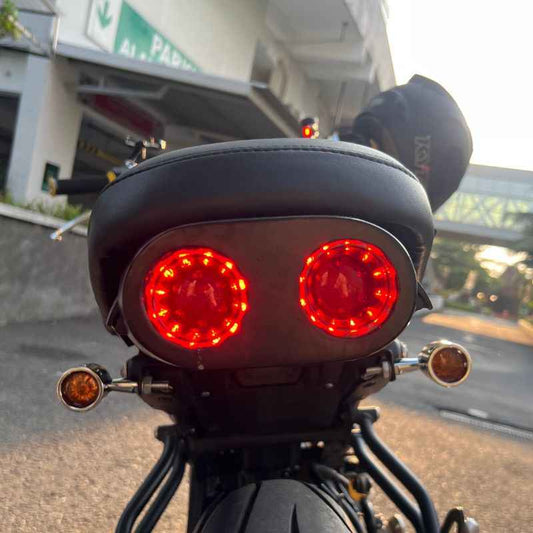 Rear view of Neo Muscle custom rear light for Yamaha XSR155 with twin round LED stop lamp, tail lamp and rear lamp integrated into a custom rear wing for café racer and custom motorcycle builds.