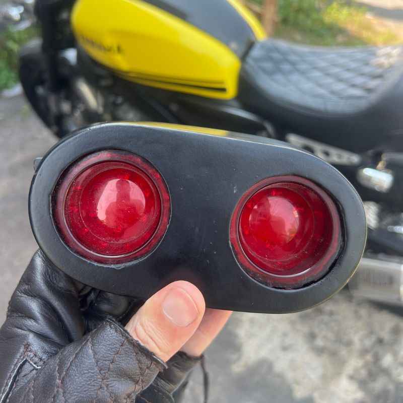 Neo Muscle custom rear light housing for Yamaha XSR155 with twin round LED stop lamp, tail lamp and rear lamp, designed for custom rear wing café racer conversion.
