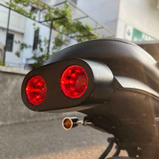 Side view of Neo Muscle custom rear light for Yamaha XSR155 featuring twin round LED stop lamp, tail lamp and rear lamp integrated into a custom rear wing for café racer builds.