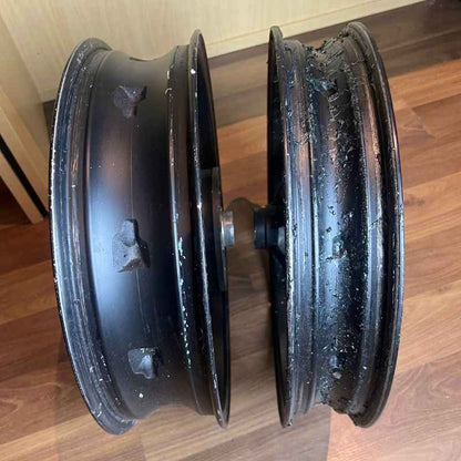 Inner rim condition of the original Yamaha XSR155 OEM wheel set (velg), showing the inside surfaces of the front and rear wheels removed from the Neo Muscle project motorcycle.